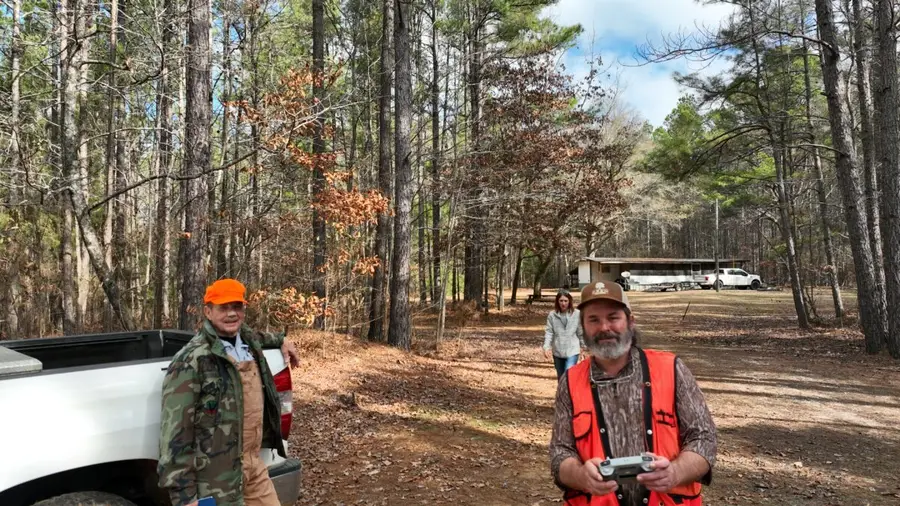 Eric Entrekin with clients near a hunting camp