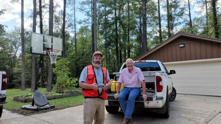 Eric Entrekin sharing a laugh with a client on a tailgate